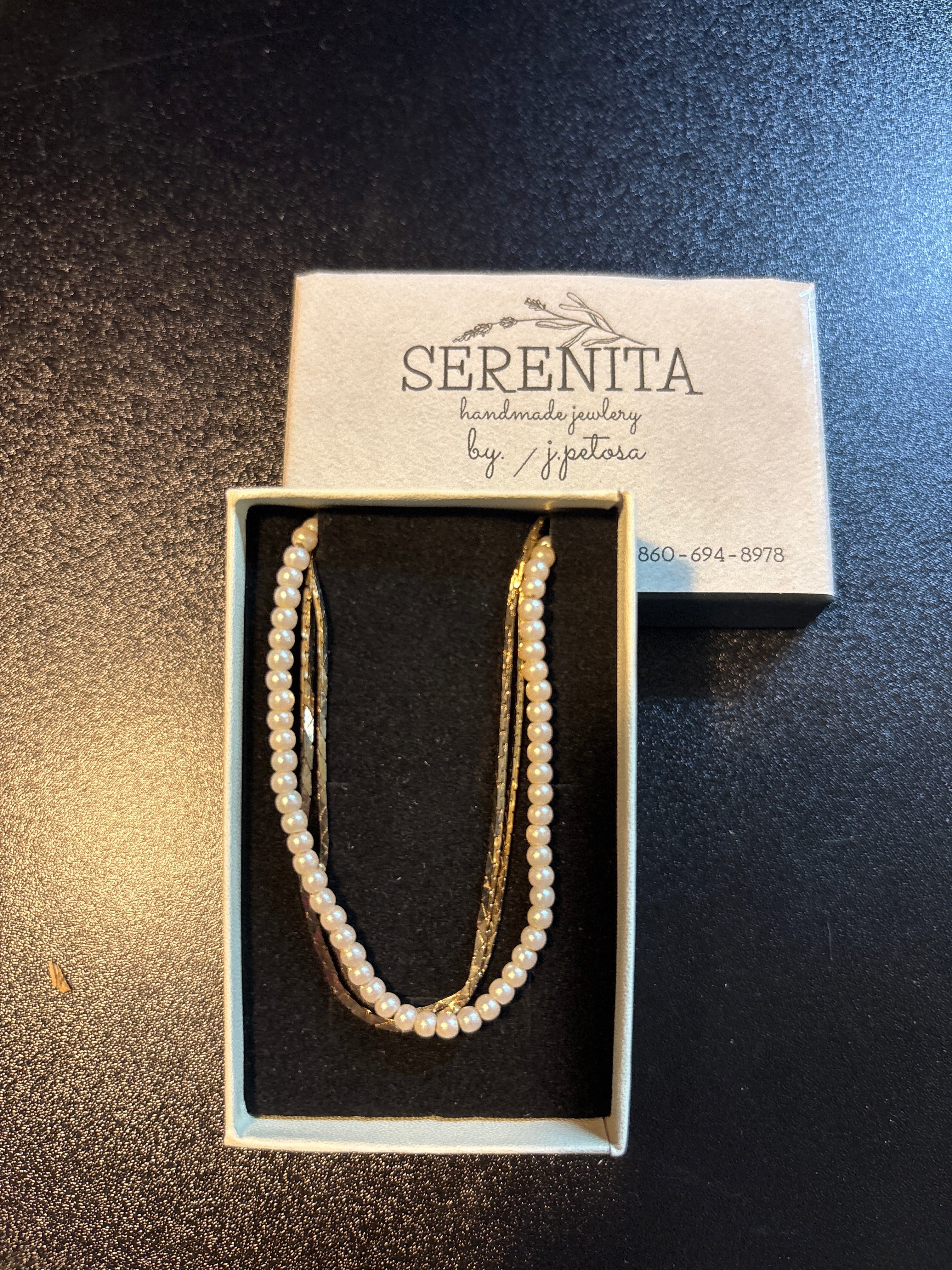 Gold tone and faux pearl necklace
