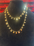 Gold tone disc charm necklace